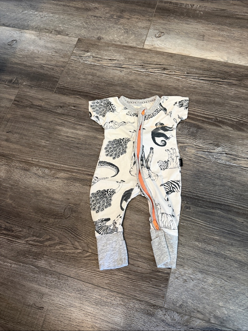 Bonds Cream Animal Print Zip One-Piece with Grey Cuffs and Orange Zip
